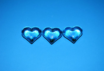 Three hearts on a blue background. Valentine's day. - 242121994