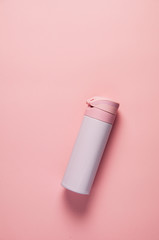 Pink thermos on pink background