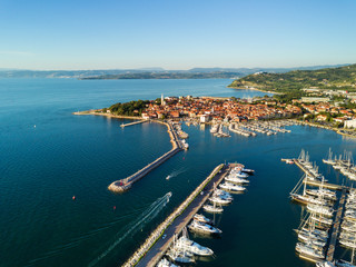 Aerial view of old fishing town Izola in Slovenia, cityscape with marina at sunset. Adriatic sea coast, peninsula of Istria, Europe.