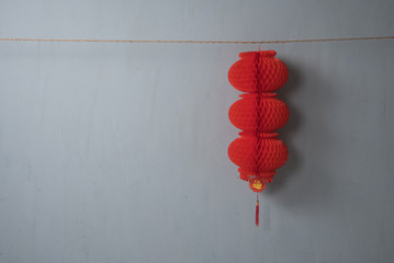 Traditional Chinese new year decoration on the rope on grey concrete textured