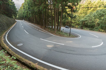 Curved winding road in forest in Wakayama, Japan