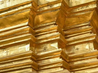 Lines and angles abstract of gilded metal sheet covering pagoda in traditional Thai Temple.