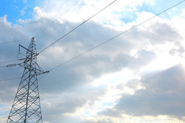 Overhead transmission of electricity through high voltage lines with ropes between high columns.