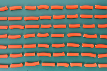 red macaroni with green background