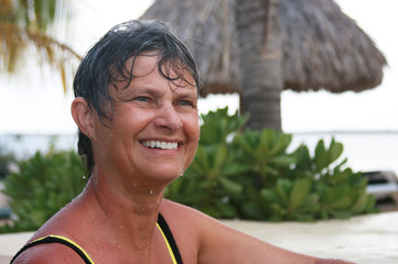 Woman smiles at a resort swimming pool