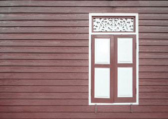 old white window and brown wall