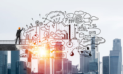 Businessman drawing business conceptual sketches.