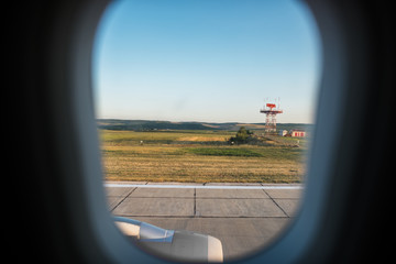 View from the window of airplane on runway of airport.