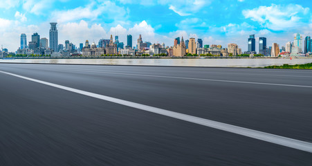 Obraz premium Empty asphalt road along modern commercial buildings in China,s cities