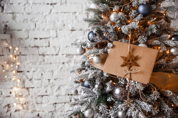 Kraft envelope lies on the branches of the Christmas tree