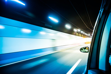 blur moving light in the tunnel from moving car at great speed. cold tone color image