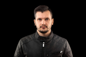 Fototapeta premium young man close up portrait, on black background
