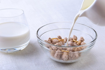 Healthy food with Corn Flakes cereal in a bowl, apple, banana and glass with milk. Morning breakfast.