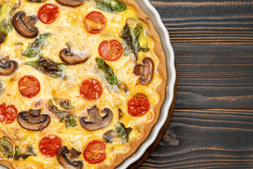 Baked homemade quiche pie in ceramic baking form