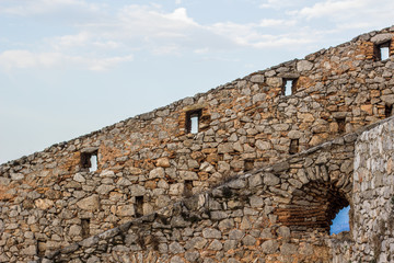 diagonal line board between stone and brick castle fortification wall construction and gray sky background wallpaper pattern, copy space  