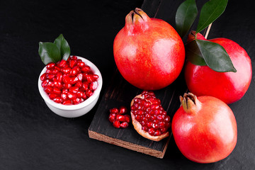 Ripe pomegranate fruits on the wooden background