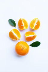 Fresh orange citrus fruit with green leaves on white.