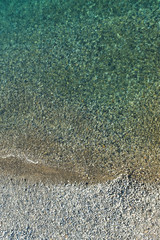 Top view aerial photo of sea waves with turquoise water from unmanned flying.