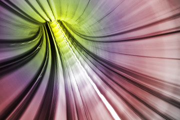 Colorful light accelerating through a tunnel.