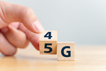 5G (5th Generation) network connecting technology future global. Hand flip wood cube change number 4G to 5G