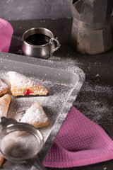 Baking tray with fresh biscuits, sprinkled with powdered sugar