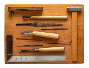  Some woodworking tools are on a cherry wood pallet.
