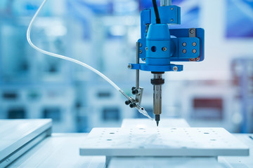 soldering iron tips of robotic system for automatic point soldering for printed and assembly electric circuit board ( PCB ) at factory