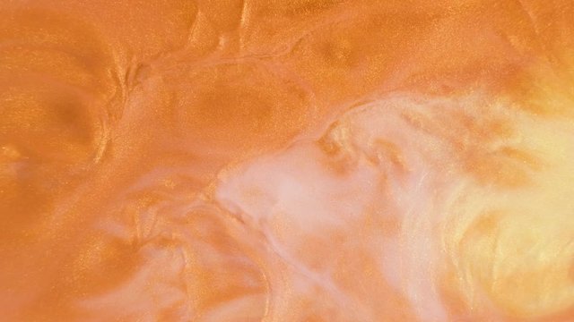 Colorful golden sand organically moves in colorful liquid