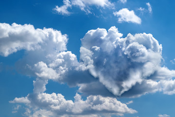 Naklejka na ściany i meble Heart shaped clouds on blue sky. Love concept