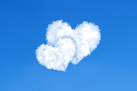 Heart shaped clouds on blue sky. Love concept