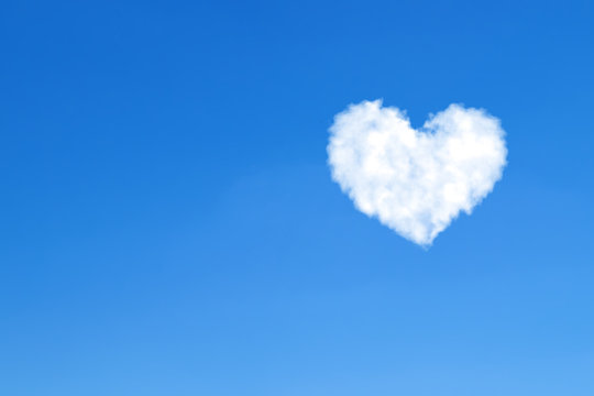 Heart shaped clouds on blue sky. Love concept