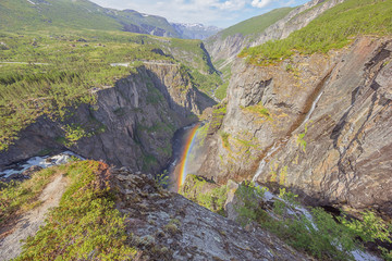 The Bjoreio River and its valley shrouded in a rainbow from the Voringfossen.