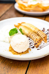 vanilla ice-cream with banana crape and whipped cream