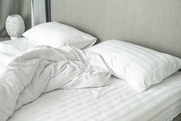 pillow on bed and with wrinkle messy blanket in bedroom