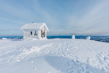 Winter snow covered wood hut. Frozen log cabin in Finland