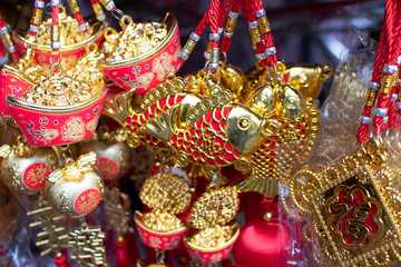 old chinese money  knot  , painted as fishes and  pig knot sell in the markets for chinese new year 2019, selective focus