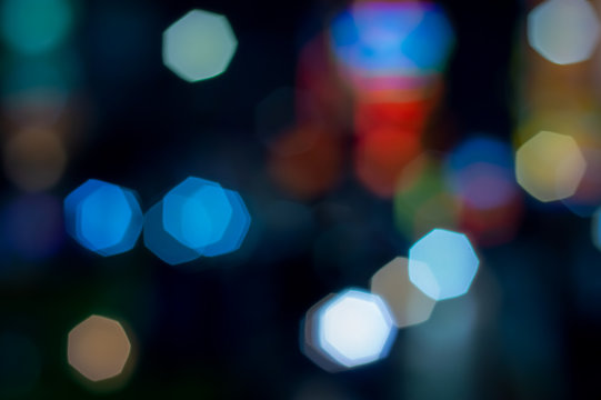 Abstract blurred textures surface pattern design bright colorful glitter geometry octagon bokeh background of Lighting from cars on the road and decorative light in the city at night time
