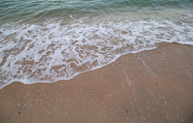 Fototapeta na wymiar Selective focus of soft wave on the beach