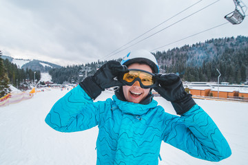 Fototapeta na wymiar portrait of young smiling woman in ski equipment. winter sport activity