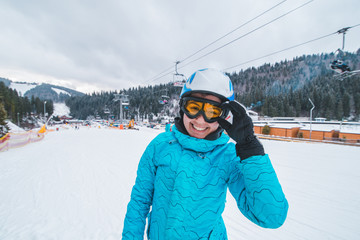 Fototapeta na wymiar portrait of young smiling woman in ski equipment. winter sport activity