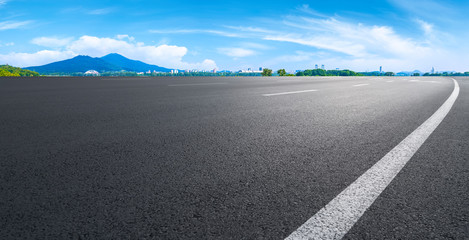 Fototapeta premium Empty asphalt road square and natural landscape under the blue sky