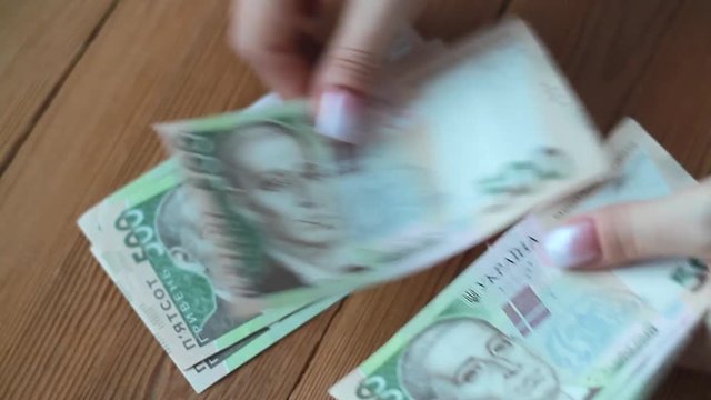 Women's hands count money. Close-up. Ukrainian hryvnia. Money in hand.