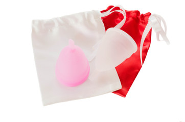 Pink and white menstrual cups with bags.