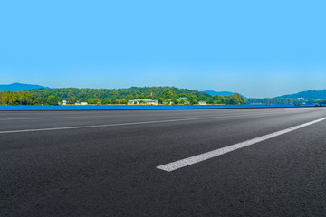 Empty asphalt road and natural landscape under the blue sky