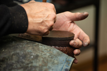 close-up of a male shoemaker's shoe glueing the sole of a shoe