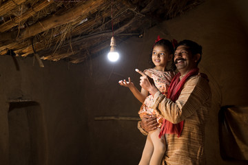 Rural Indian father with daughter delighted on electricity reaching their home