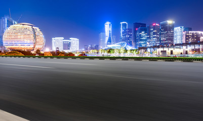 Fototapeta na wymiar Road Pavement and Night View of Hangzhou Urban Architecture..
