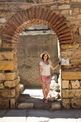 Beautifull brunette girl in the hat on a walk in Nessebar. Bulgaria