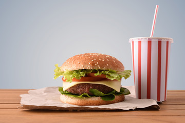 Beef burger on wooden table with soda gary backgorund © Davizro Photography