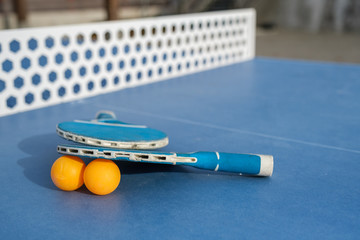 outdoor ping pong paddles, ball, and net
